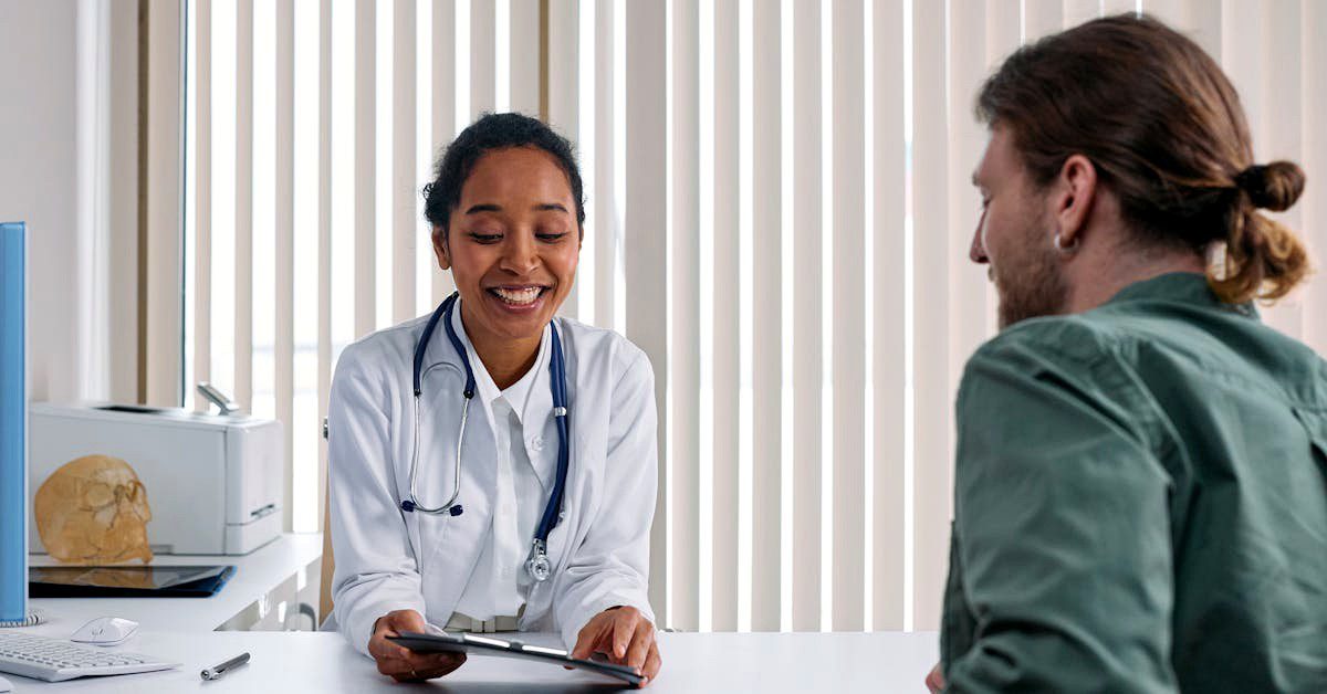 a doctor in a private clinic consultation room discussing results with a patient — illustrating the cost of a private colonoscopy in the UK