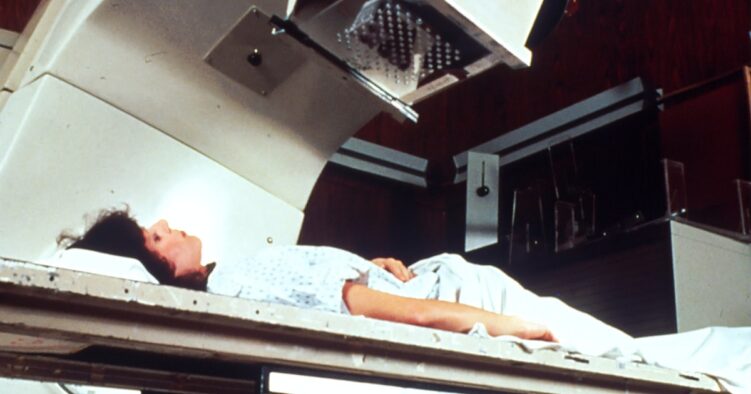 Cost of a DEXA bone density scan A patient lying on a scanning table during a medical imaging procedure, showing the outside view of a DEXA bone density scan.